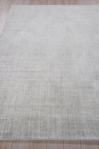 Rectangular flatweave beige-gray rug with subtle textured weave for modern living spaces.