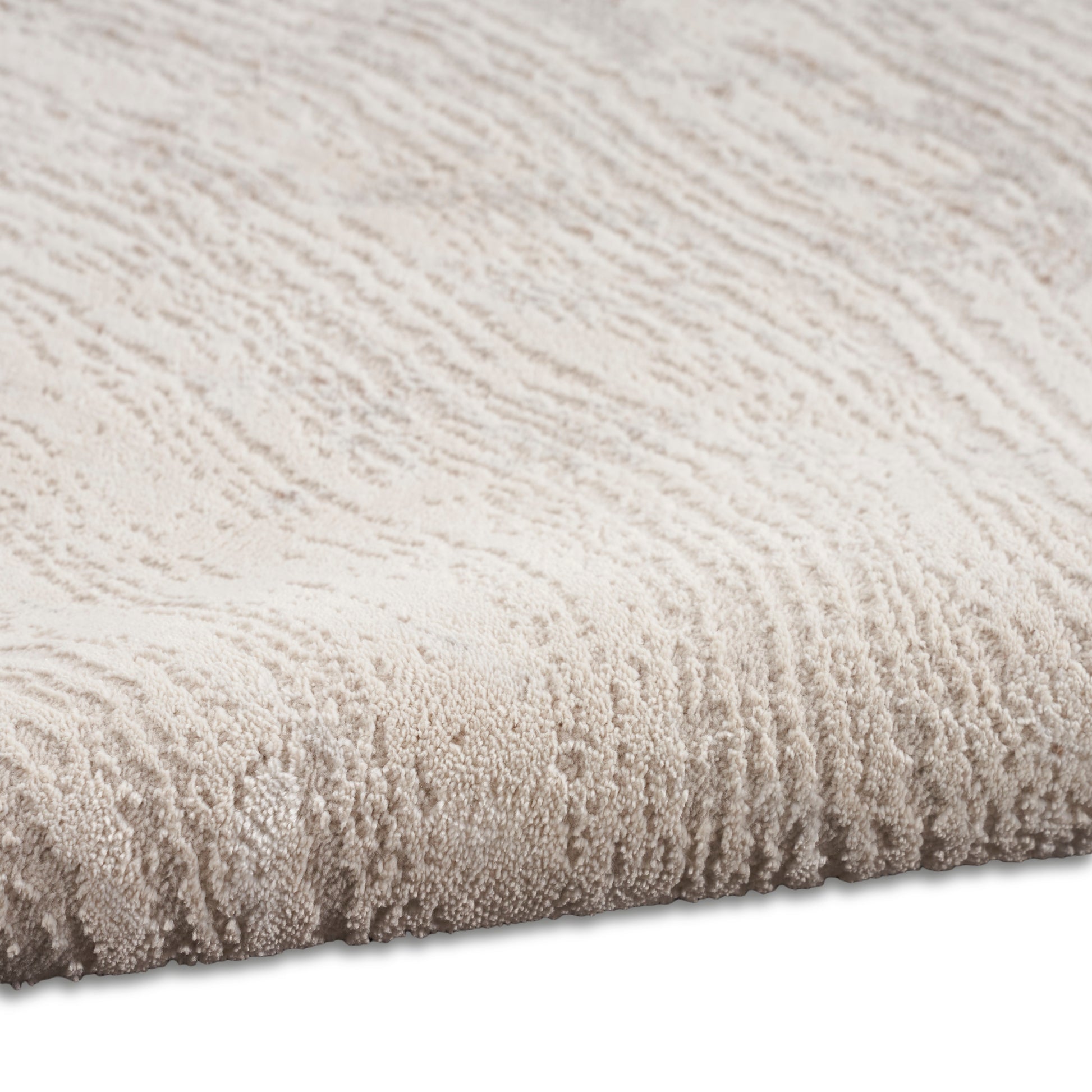 Beige textured loop-pile rug; soft plush surface with subtle ridges, edge view for neutral floor decor.