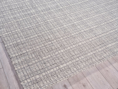 Gray woven area rug with subtle grid texture on light wood flooring.