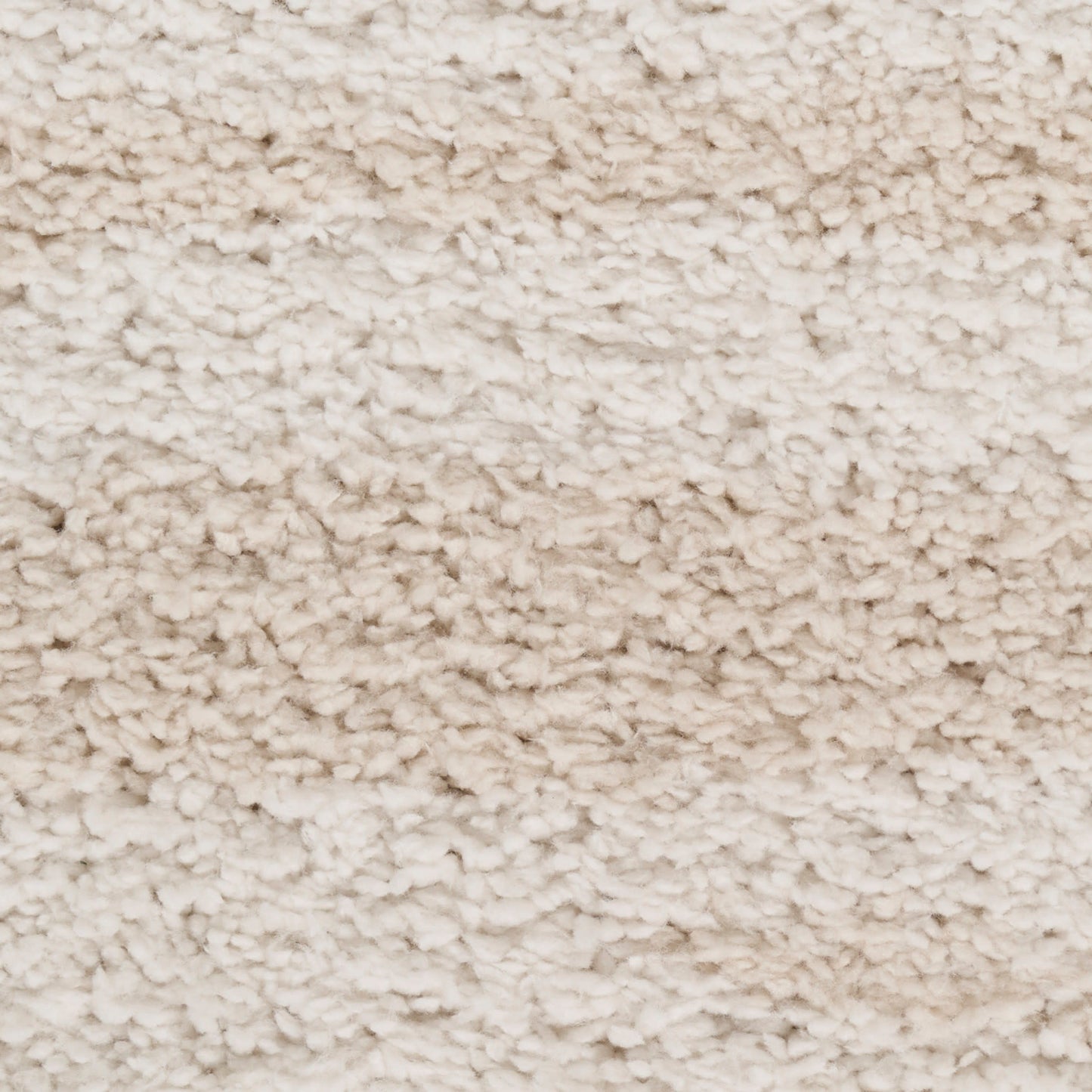 Cream shaggy carpet close-up showing plush, high-pile beige fibers.