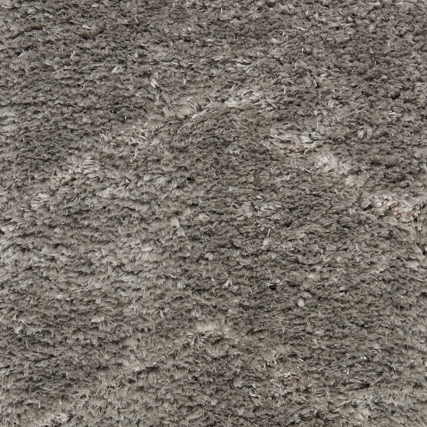 Soft, high-pile shag rug in taupe-gray with dense, fluffy fibers.
