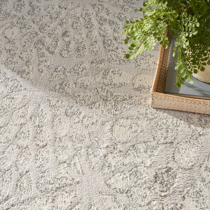 Light grey textured rug with subtle pattern.