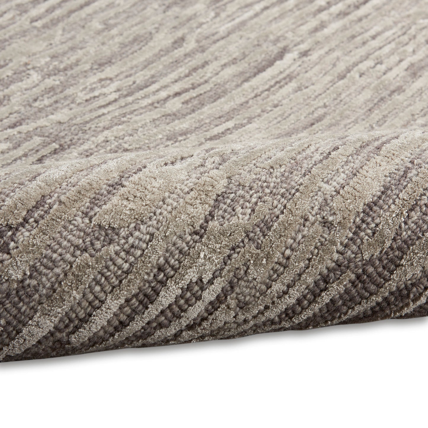 Neutral beige-gray rug with textured loop-pile surface and subtle striped pattern.