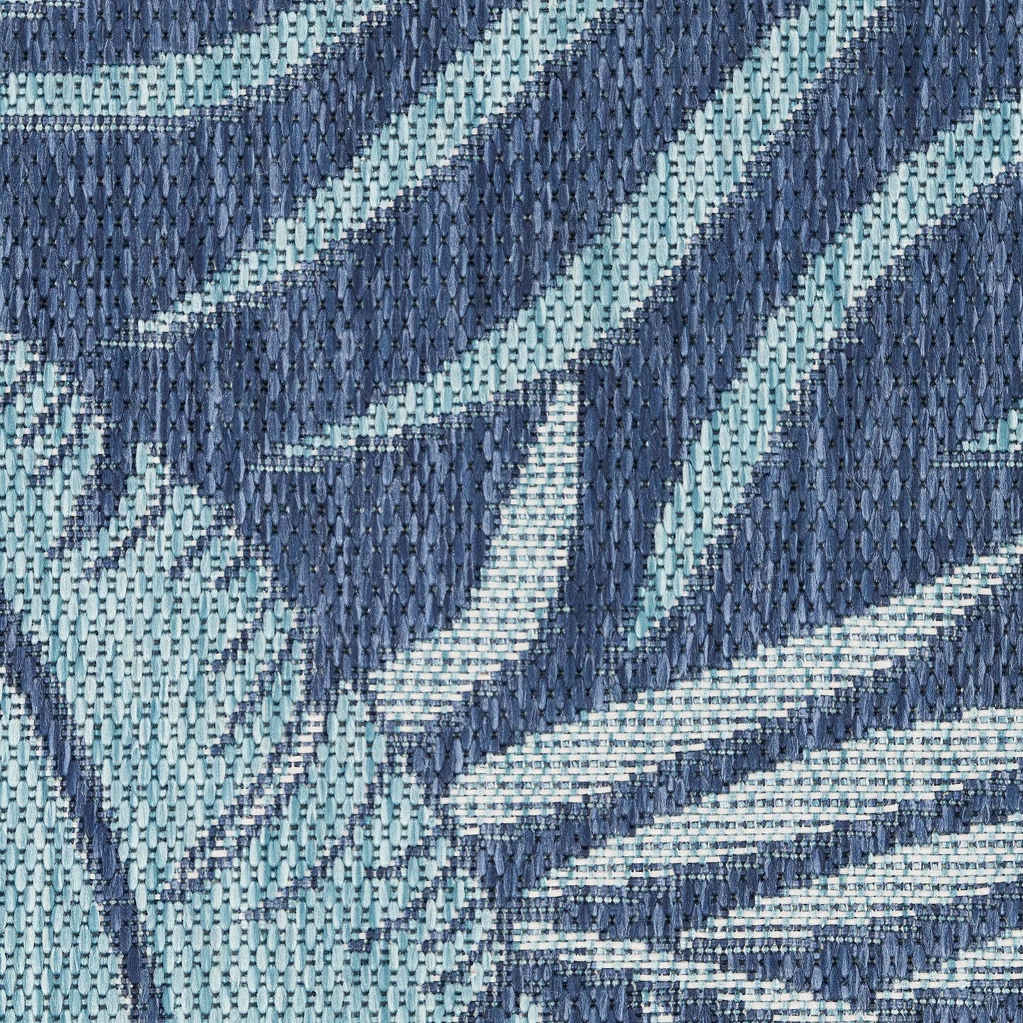 Close-up woven textile in navy & light blue with bold diagonal stripes; textured fabric for upholstery or decor.