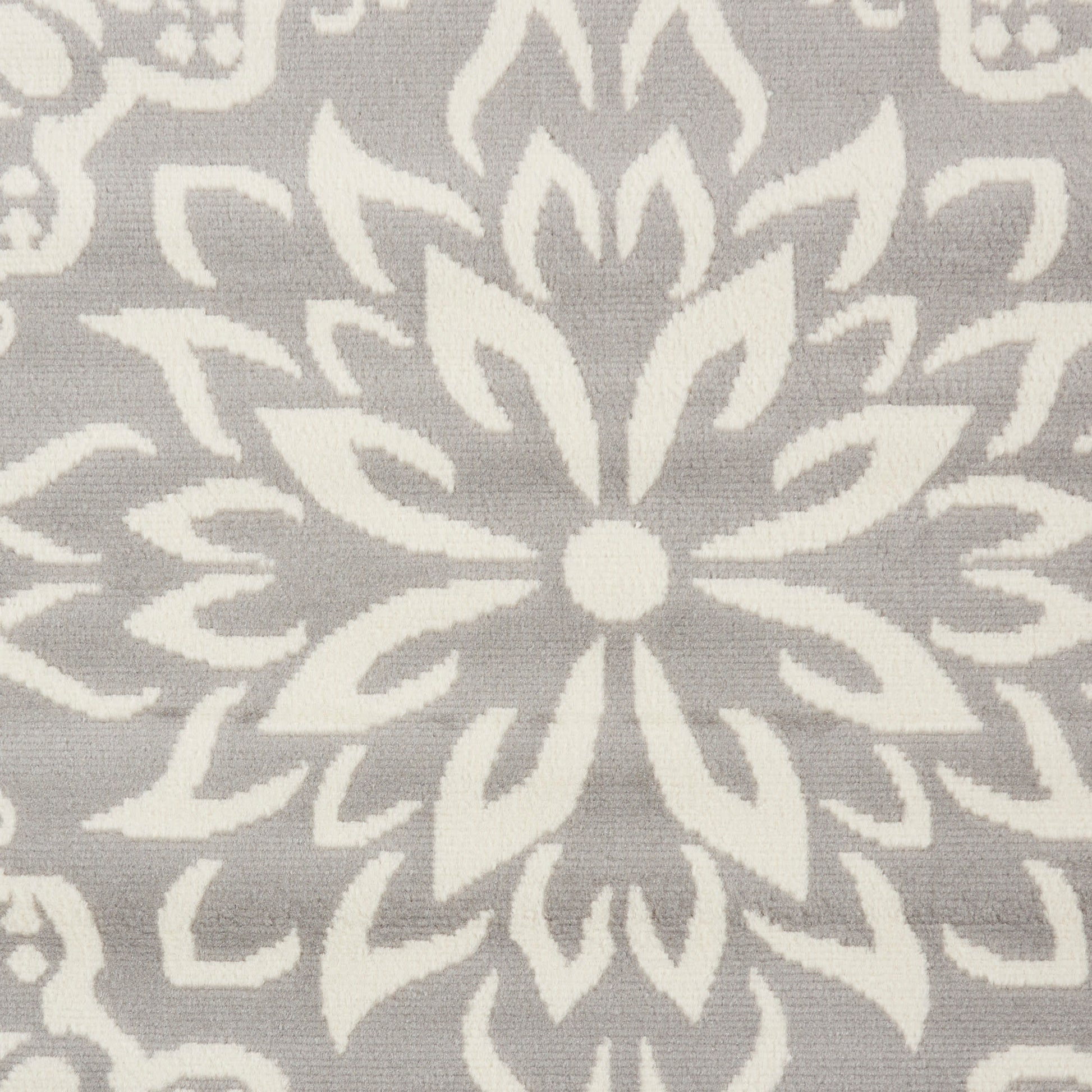 Round 8' farmhouse rug in gray woven fabric with a white damask floral motif and mandala-style centerpiece.