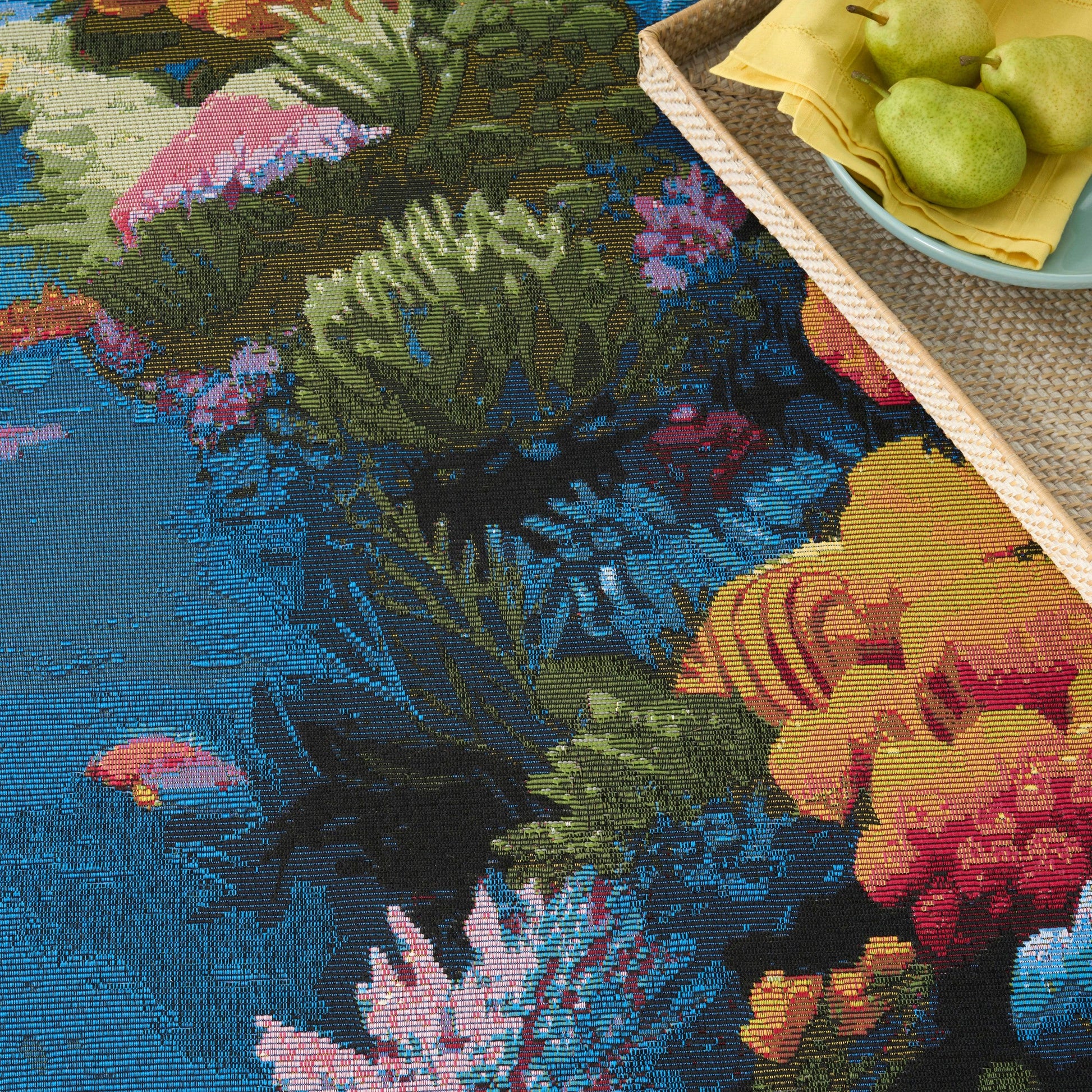 Colorful floral tapestry rug in blues and greens.
