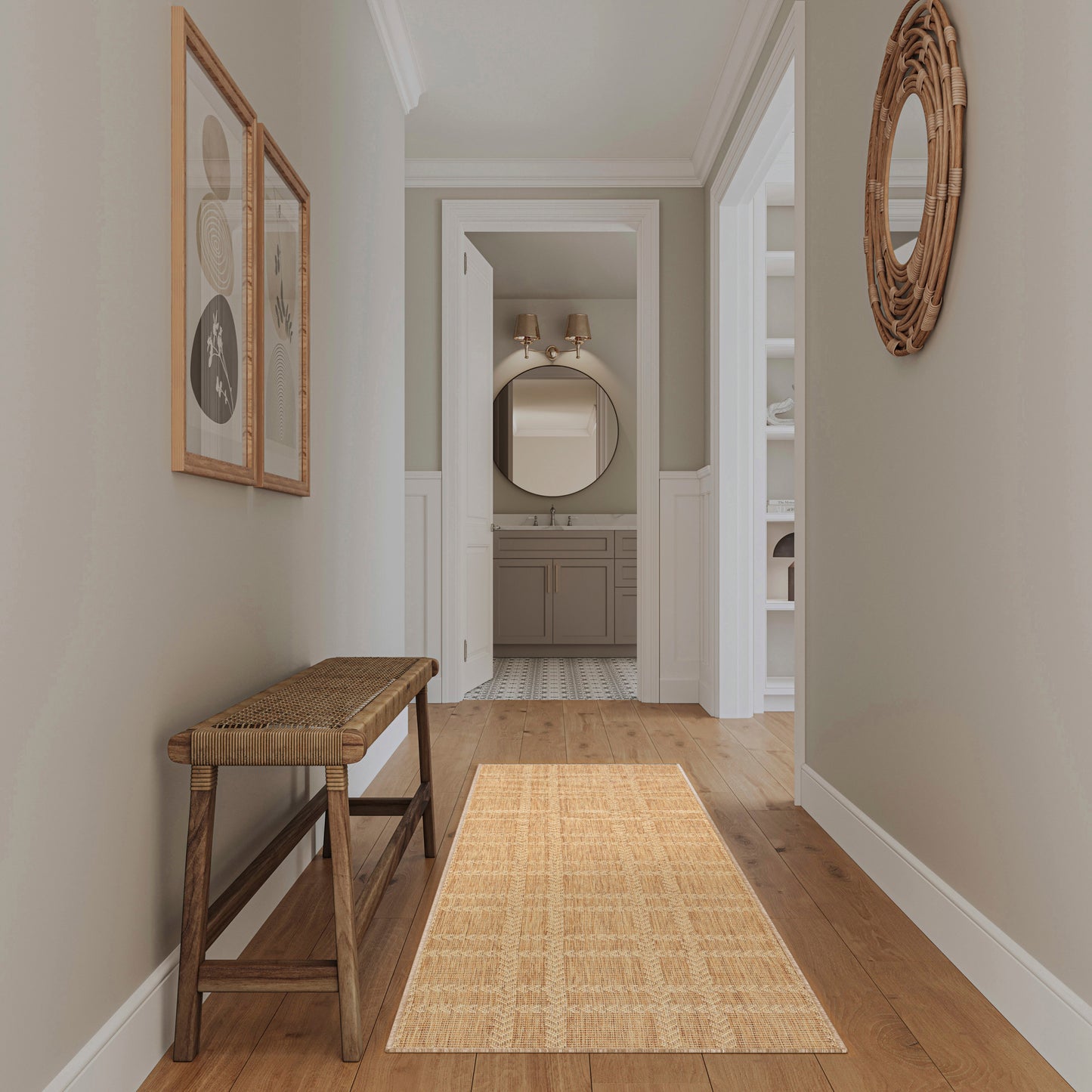 Coastal farmhouse hallway with wood floor, woven bench, natural fiber runner, round wicker wall mirror, wainscoting, leading to bathroom.