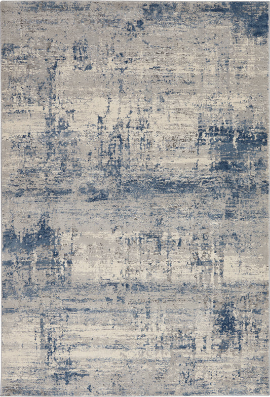 Abstract blue and beige distressed area rug with painterly pattern, modern living space decor.