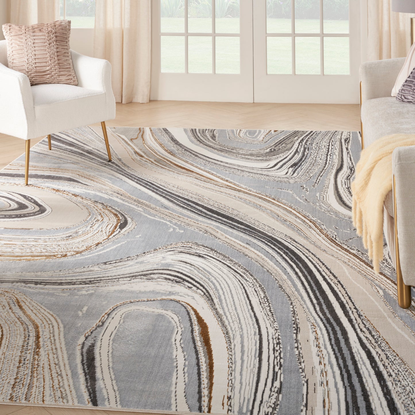 Abstract swirl-pattern area rug in gray, beige and tan for modern living rooms.