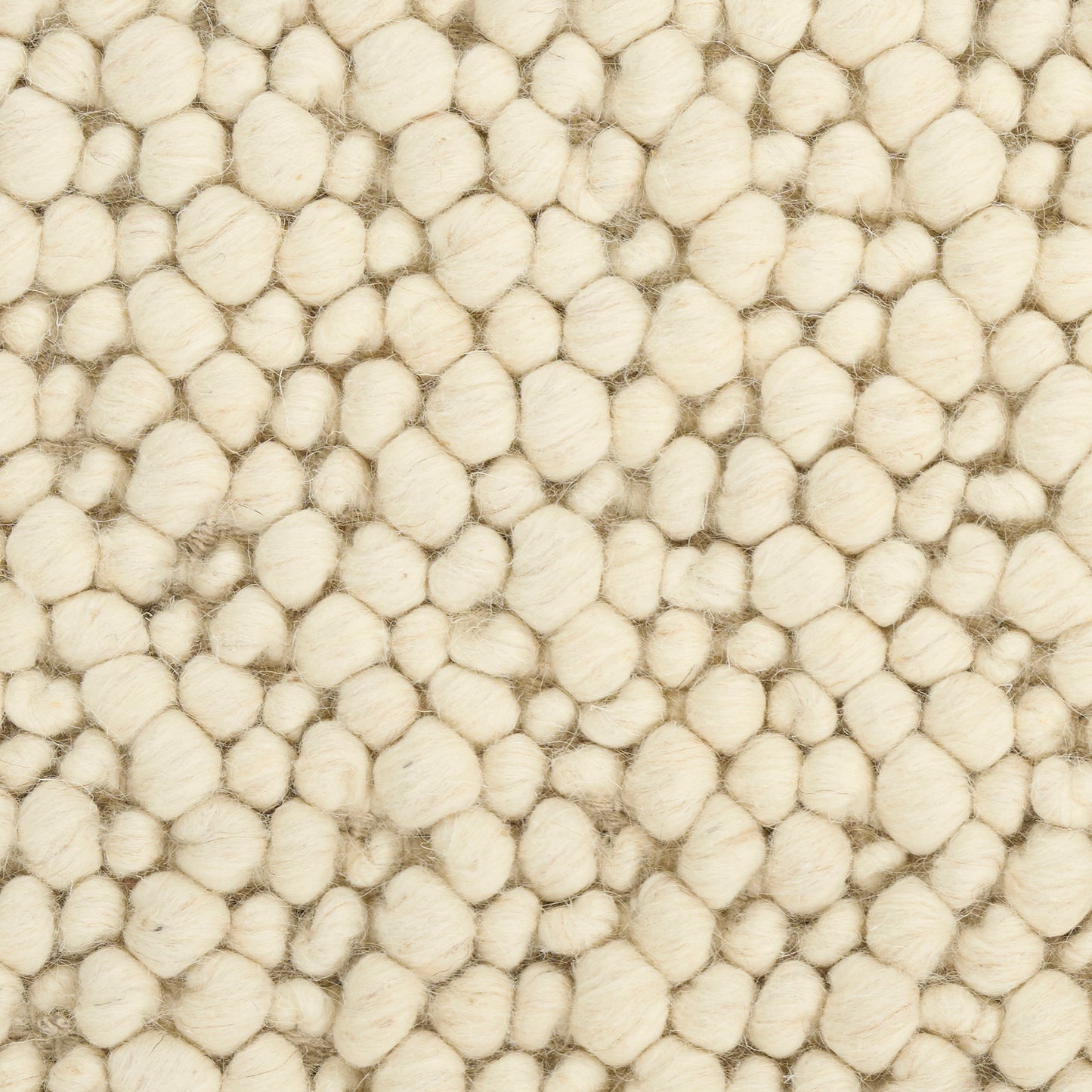 Cream boucle wool rug texture with densely packed round tufts, soft and cozy.