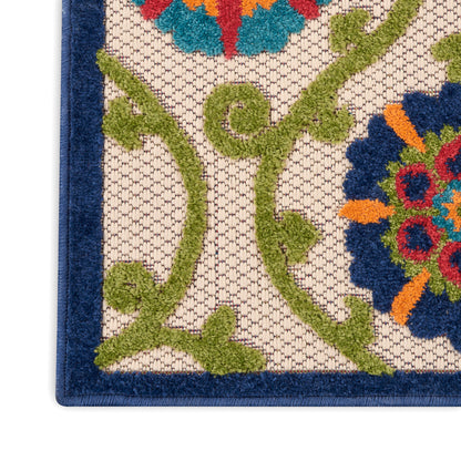 Beige contemporary runner rug with green scrolling vines and bright multicolor flowers, dark blue border.