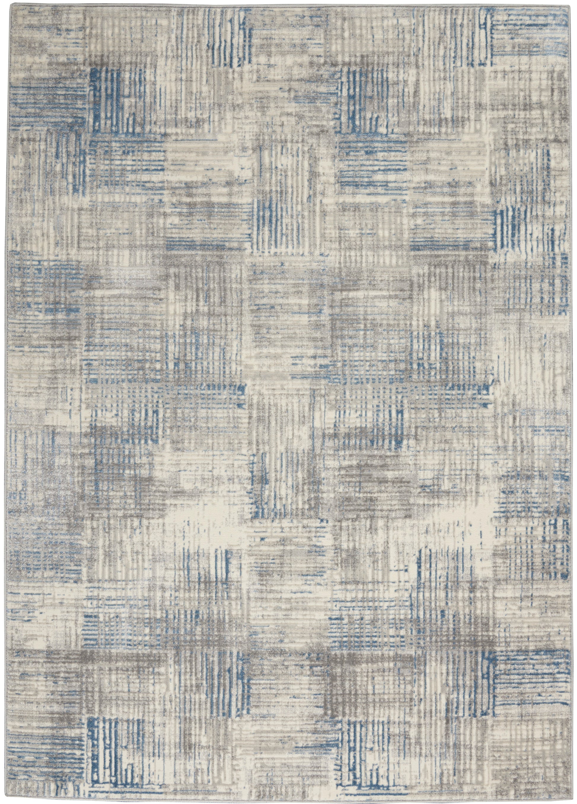 Modern area rug in beige and gray with blue patchwork squares; textured geometric pattern for living room.