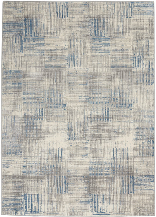 Modern area rug in beige and gray with blue patchwork squares; textured geometric pattern for living room.