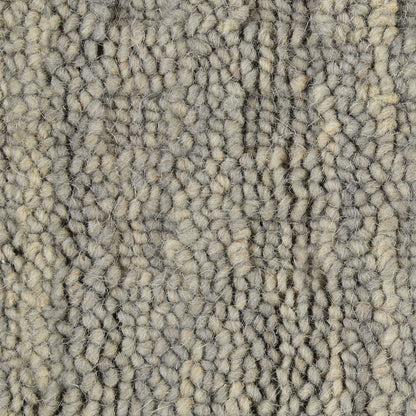 Neutral gray-beige loop-pile rug runner close-up; dense textured yarns for a soft, durable floor covering.