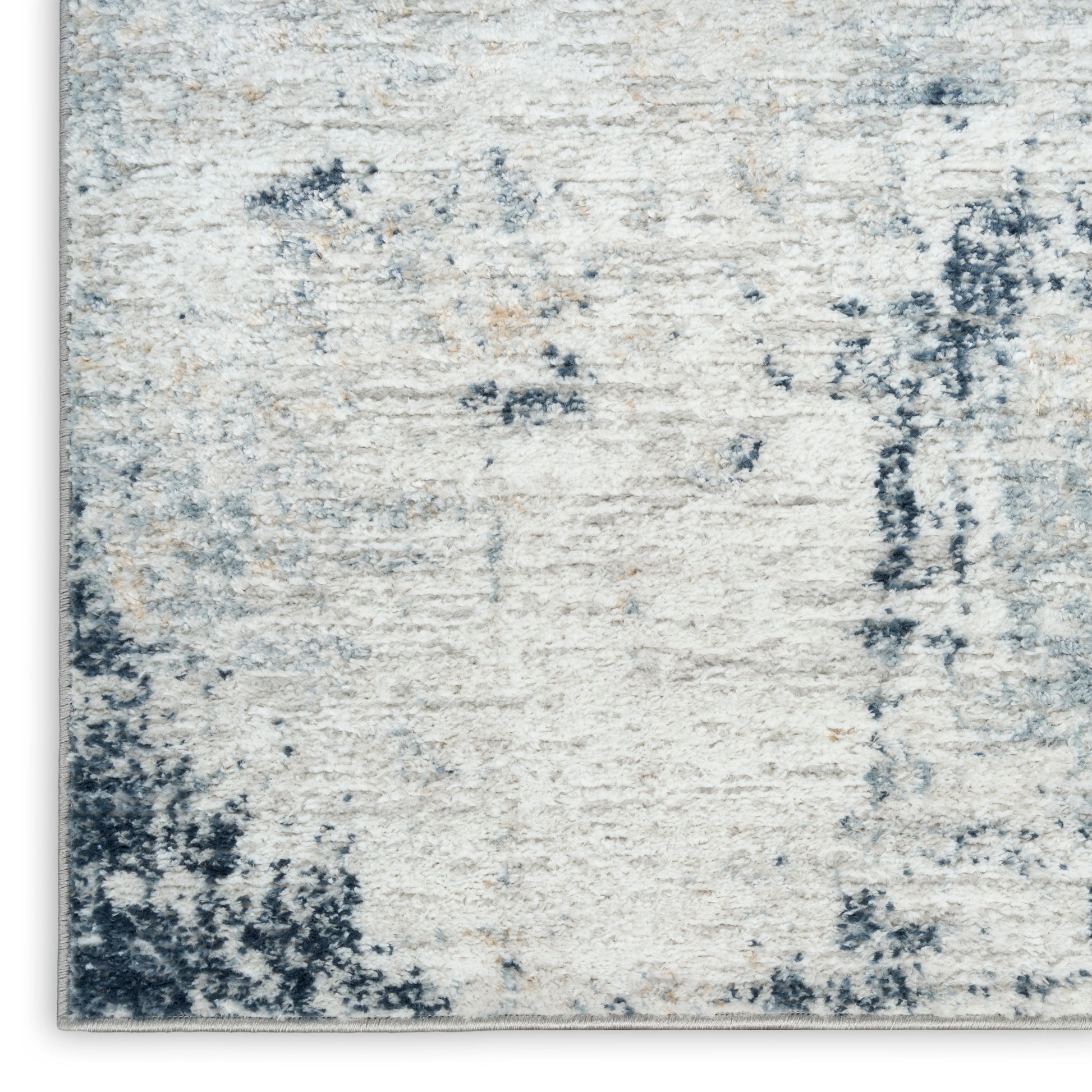 Rectangular cream and blue abstract rug with distressed pattern, plush pile, modern coastal style for living rooms.