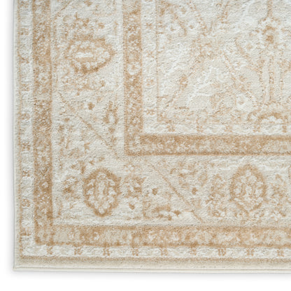 Cream-beige textured rug with ornate tan border and floral motifs; soft, plush pile.