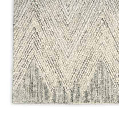 Cream and beige chevron rug with textured shag pile, modern geometric décor.