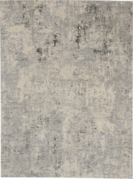 Abstract distressed beige-gray area rug with a mottled, neutral-toned texture.