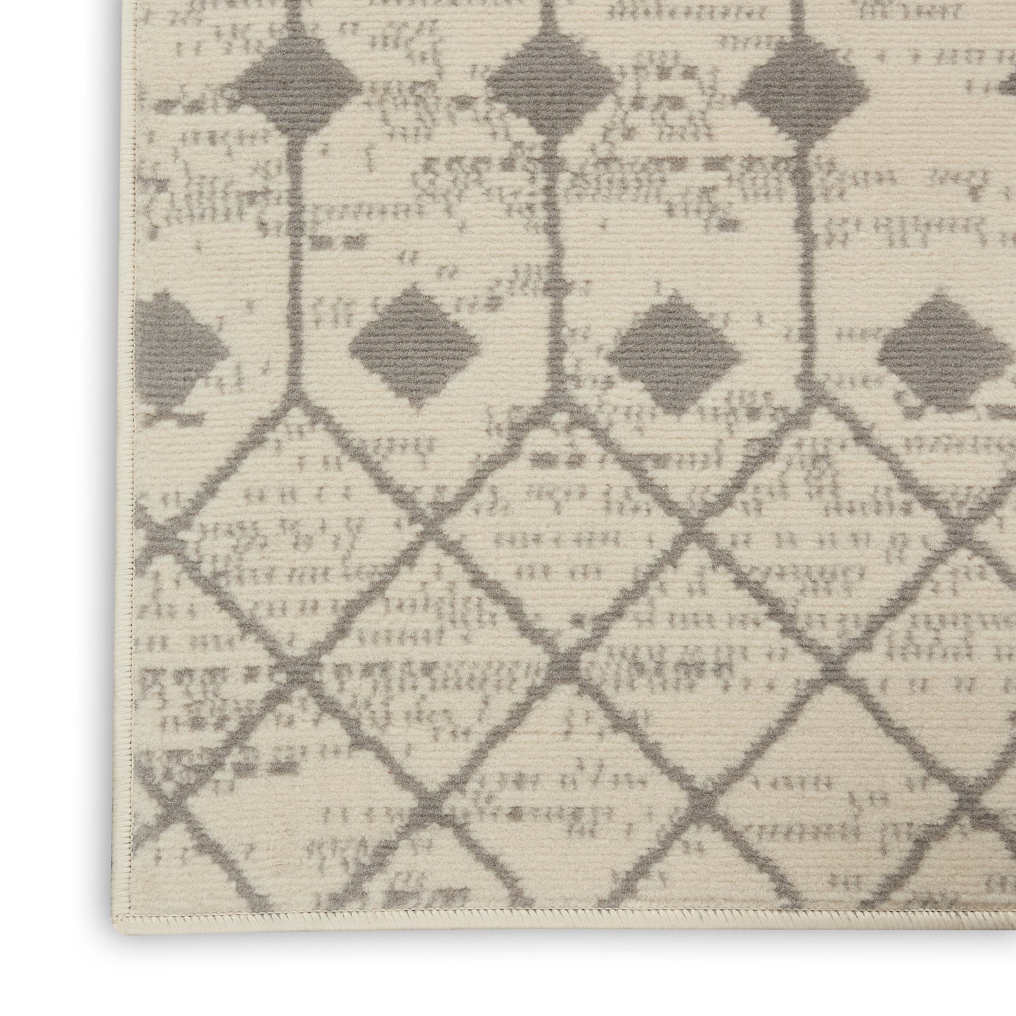 Beige woven area rug with taupe diamond lattice pattern and subtle distressed look.
