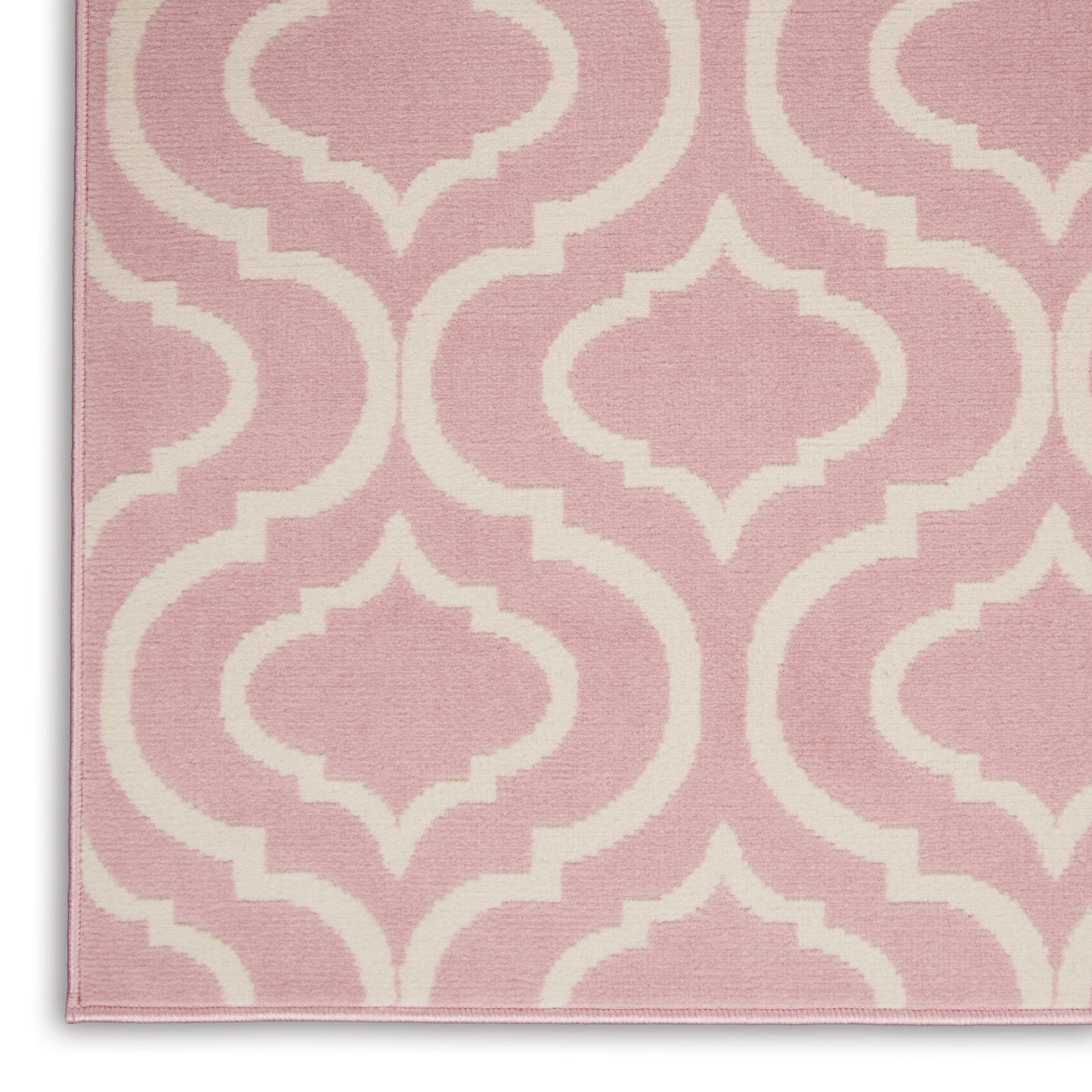 Pink rug with white trellis pattern, woven textile, soft decorative accent for living room or bedroom.