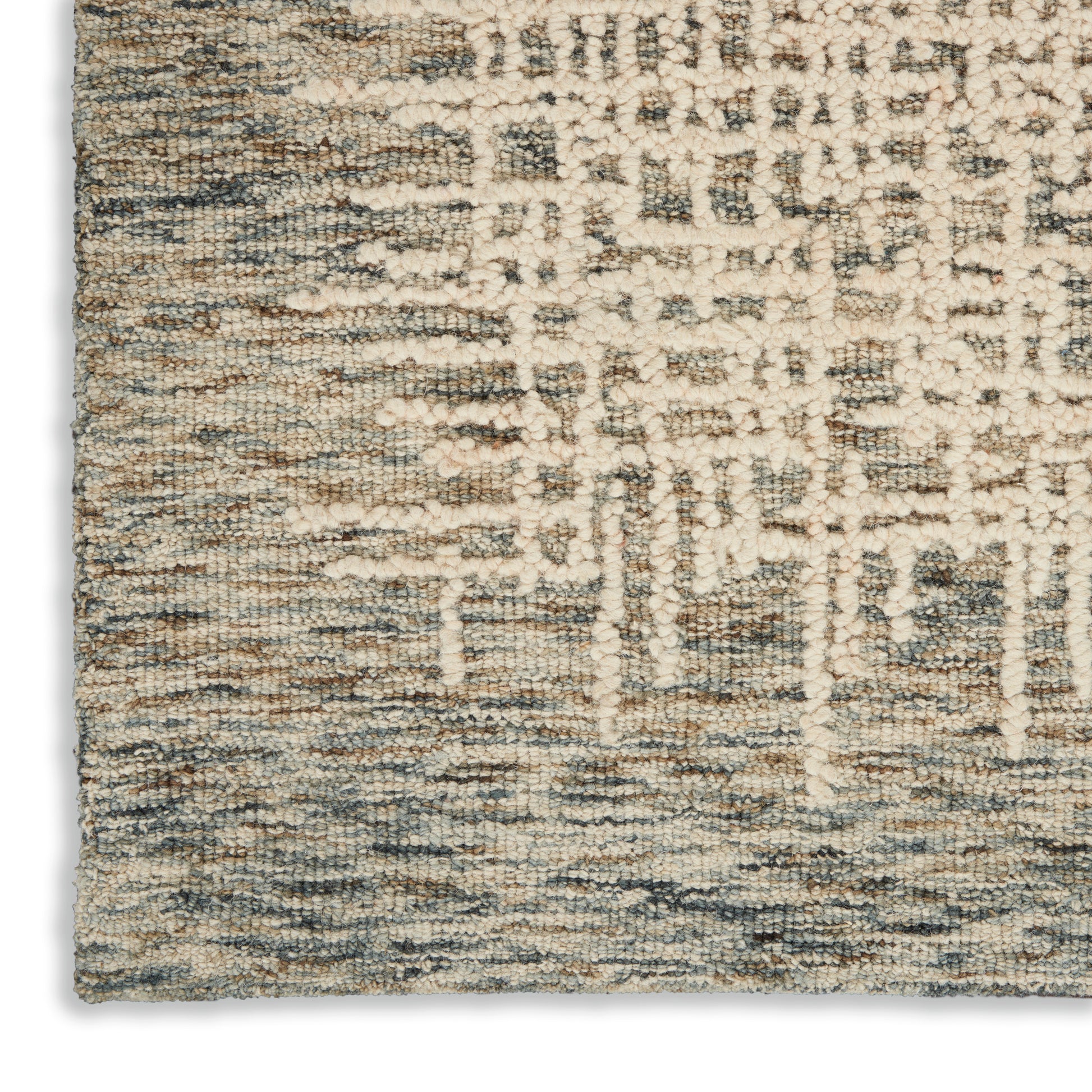 Close-up of a rectangular textured rug in cream, beige & blue-gray with an abstract geometric pattern and loop pile.