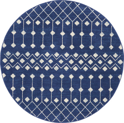 Round navy-blue rug with white geometric lattice and diamond motifs; modern coastal/boho style.