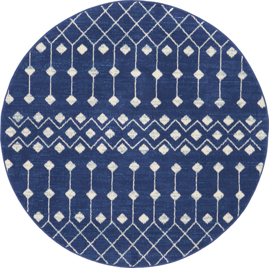 Round navy-blue rug with white geometric lattice and diamond motifs; modern coastal/boho style.