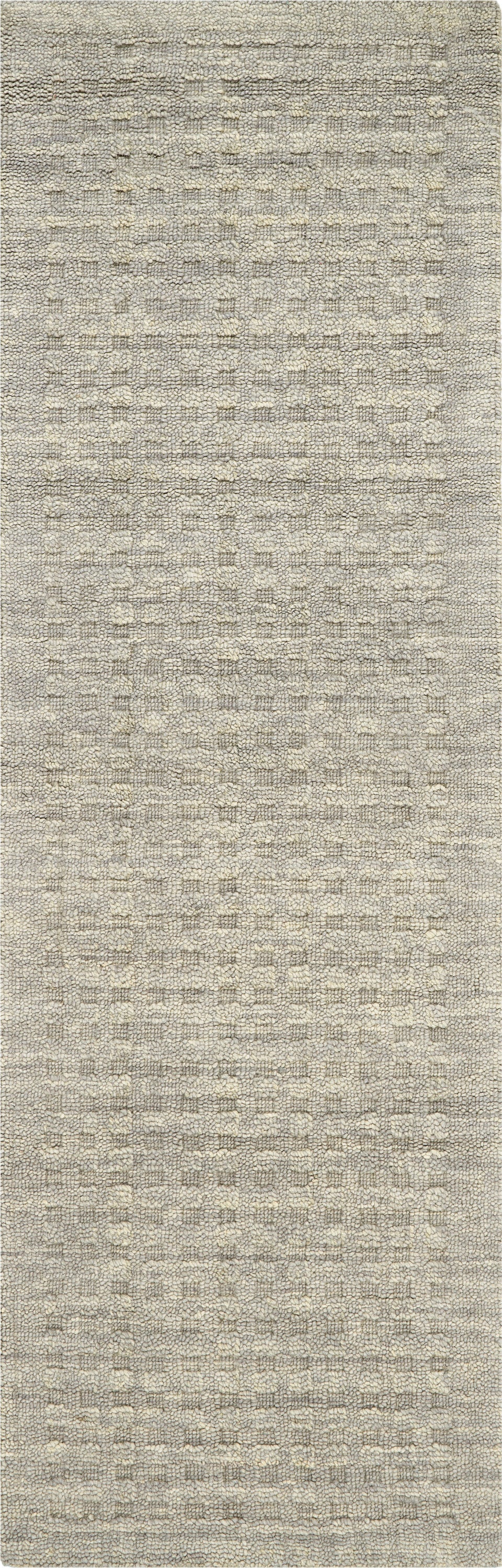 Beige textured woven rug with subtle cream grid pattern and loop pile.