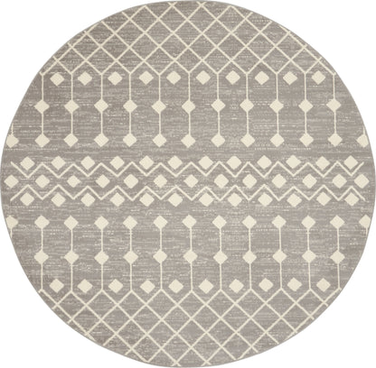 Round taupe rug with cream geometric lattice diamonds and chevron bands.