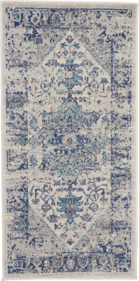 Rectangular blue-and-ivory distressed oriental rug with central medallion and floral motifs.