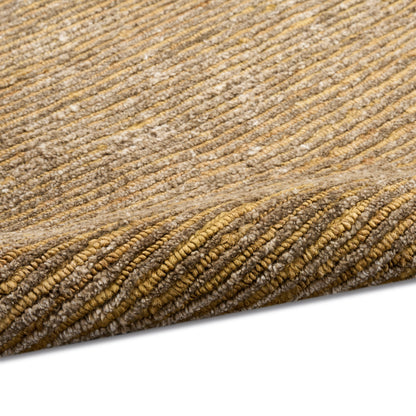 Tan and caramel striped ribbed loop-pile rug with folded corner.