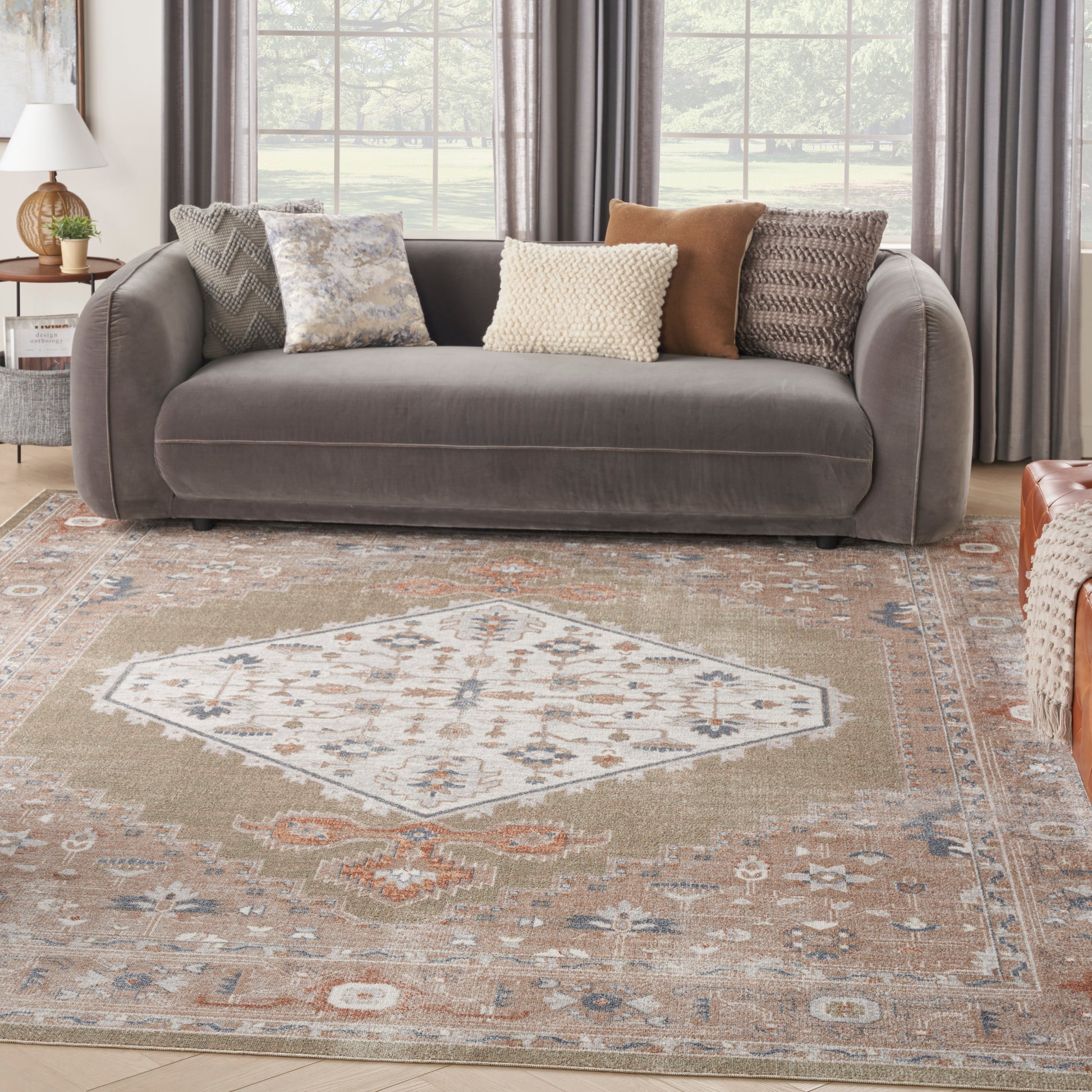 Beige geometric rug with a central diamond pattern in a bright living room.