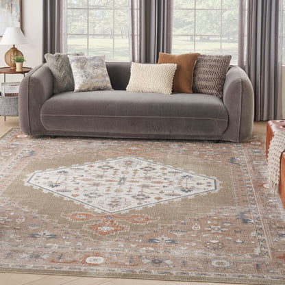 Beige geometric rug with a central diamond pattern in a bright living room.