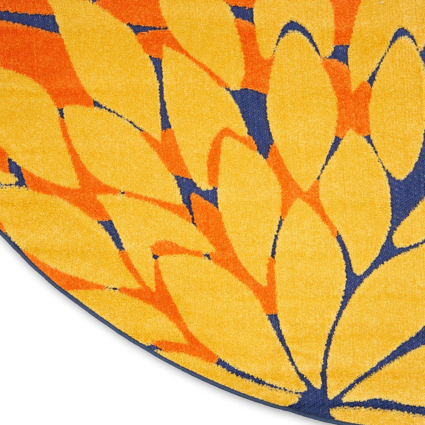 Round decorative rug with yellow & orange leaf shapes on navy blue background; soft plush pile.