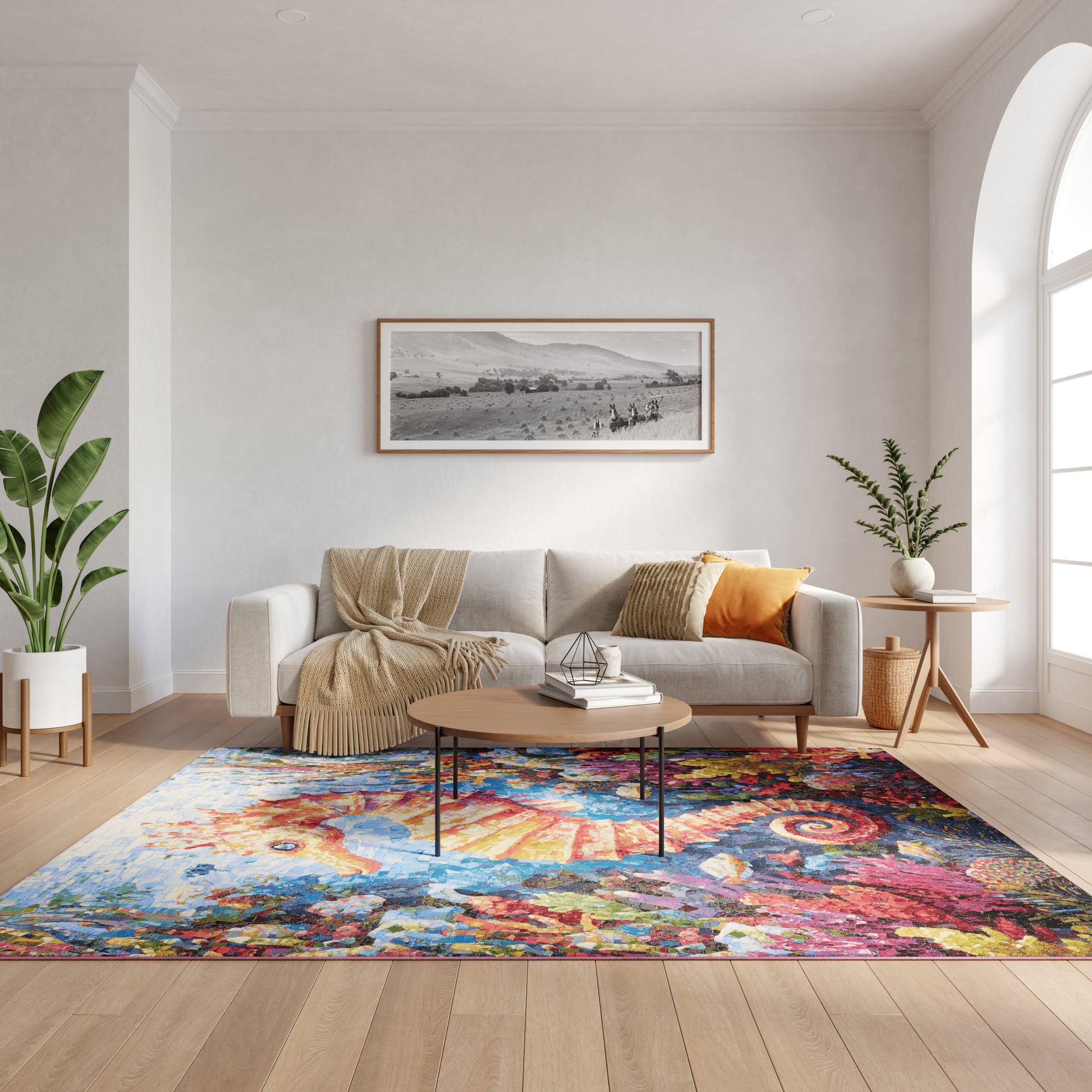 Modern living room with light gray sofa, beige throw, vibrant rug, round wood coffee table, arch window, and potted plants.