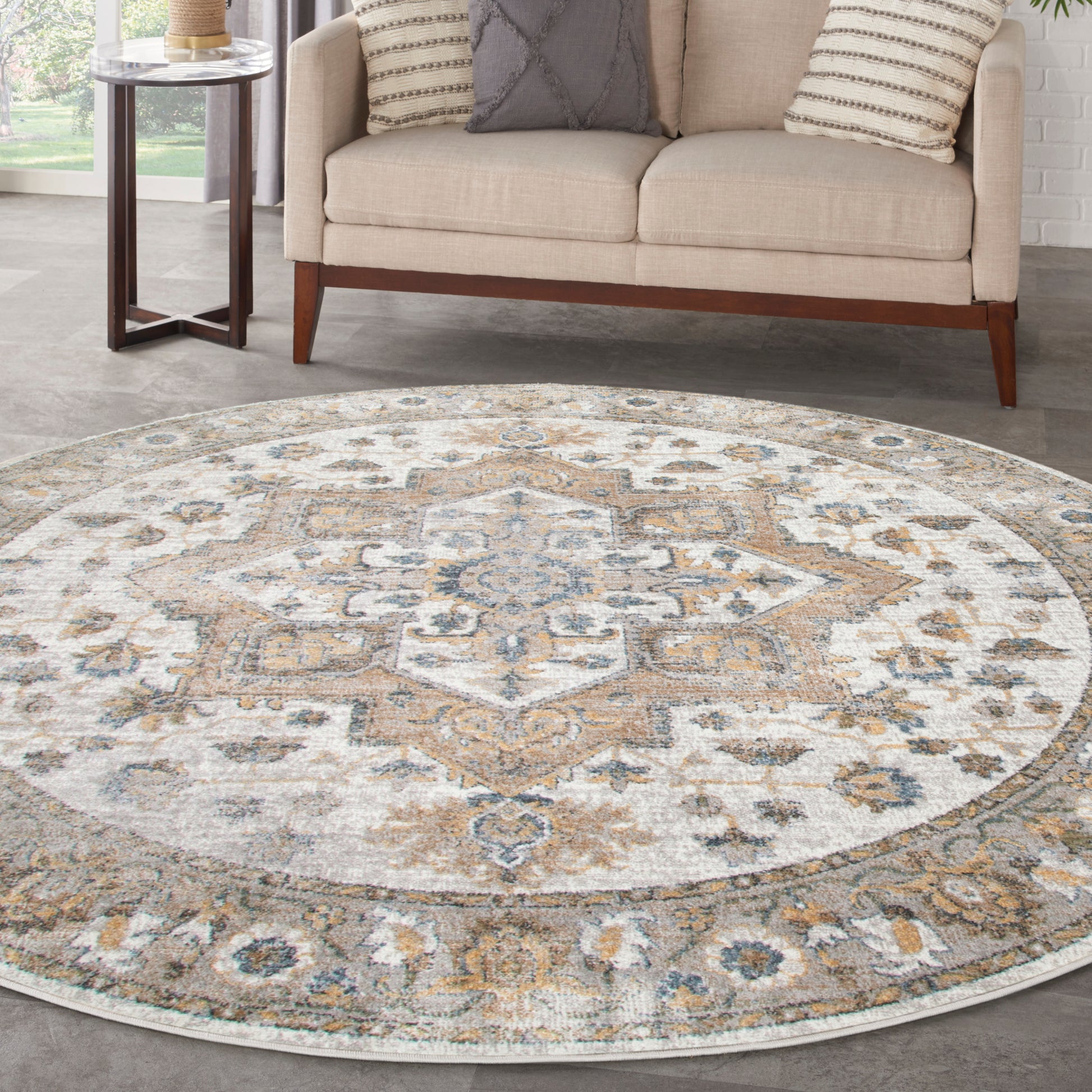 Round vintage-style area rug with ornate medallion in beige, ivory, gray & pale blue; plush low-pile in living room.