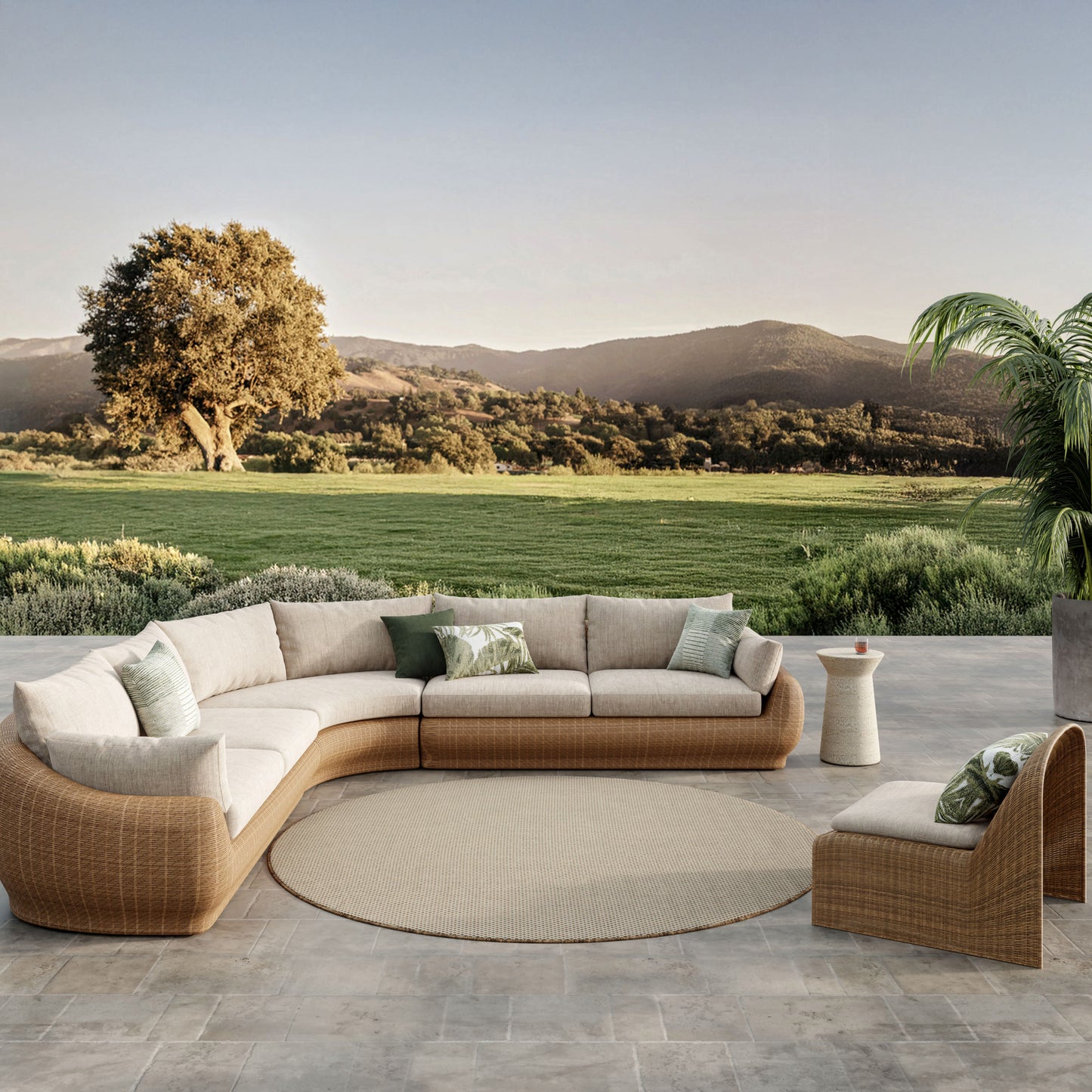 Outdoor round rug on a patio with a scenic view of green fields and hills
