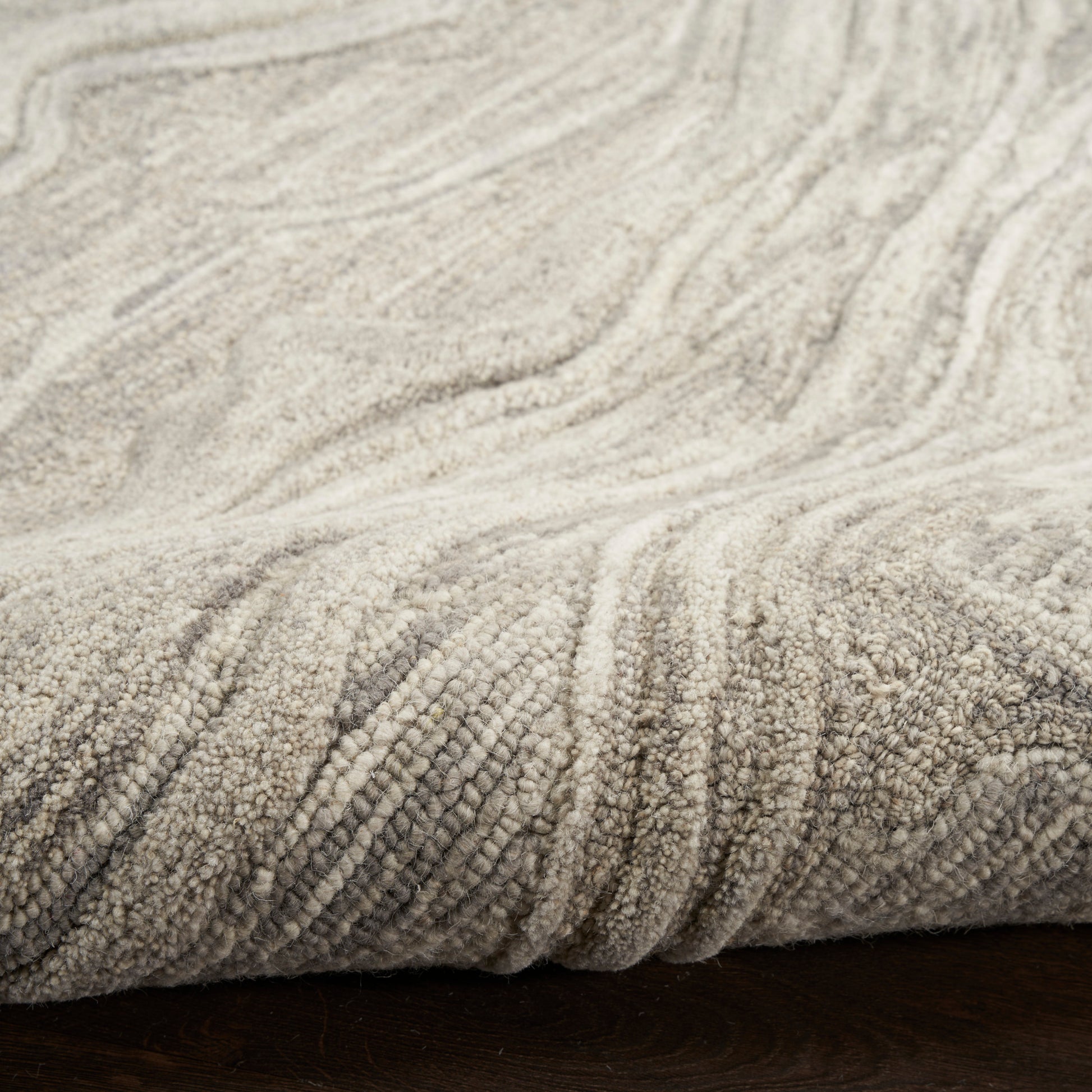 Beige textured rug runner with looped pile and soft, wavy pattern.