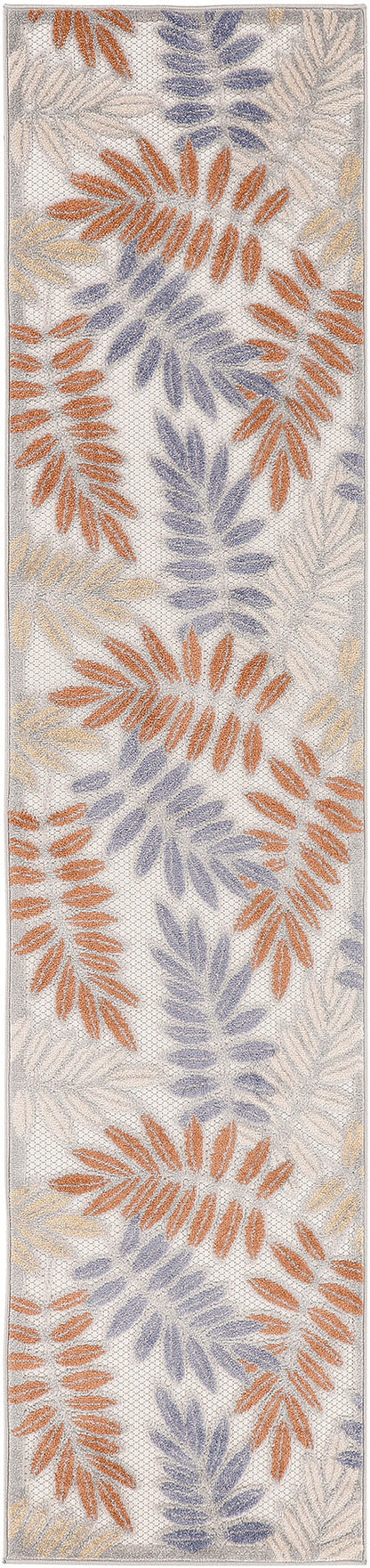 Long outdoor 8' runner rug with fern-like leaf patterns in orange, lavender and beige on a light cream background.