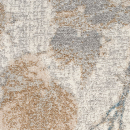 Close-up of a textured abstract area rug in beige, taupe, gray and pale blue with a soft plush pile.