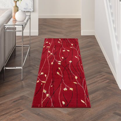 Red hallway runner rug with abstract black vines and beige leaves, in a modern entryway on herringbone wood floor.