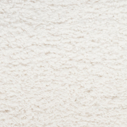 Cream shag rug close-up shows plush fluffy pile, soft textured surface for cozy living room decor.