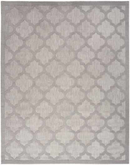 Soft neutral area rug with ivory background and taupe-gray quatrefoil trellis pattern; textured pile with subtle border.