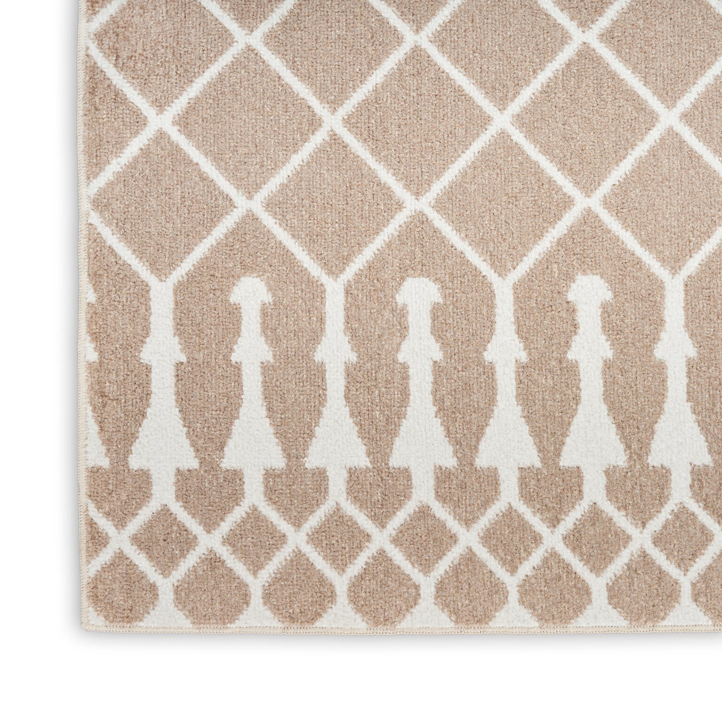 Beige rug with white diamond lattice and arched motifs; soft woven texture, neutral decor for living spaces.