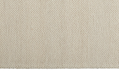 Beige woven fabric with tiny hexagonal basket-weave texture, soft upholstery textile for home decor.