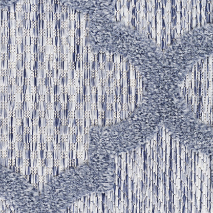 Blue and gray woven rug with plush X-shaped cross motif on a textured chevron background.