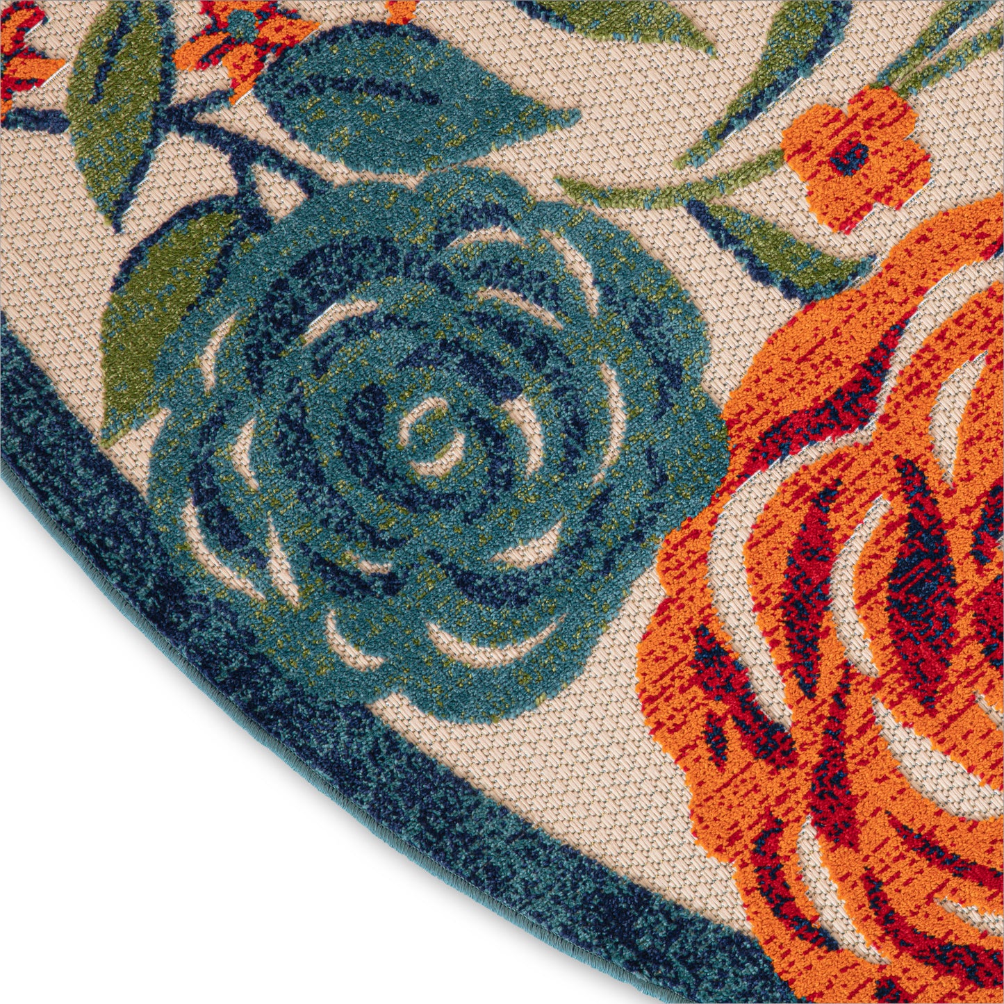 Outdoor 5' round floral rug close-up showing teal blue and orange roses on beige woven background with a dark blue edge.