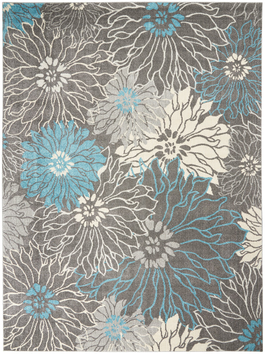 Abstract floral area rug with large blue-teal and cream petals on gray background; modern woven design.