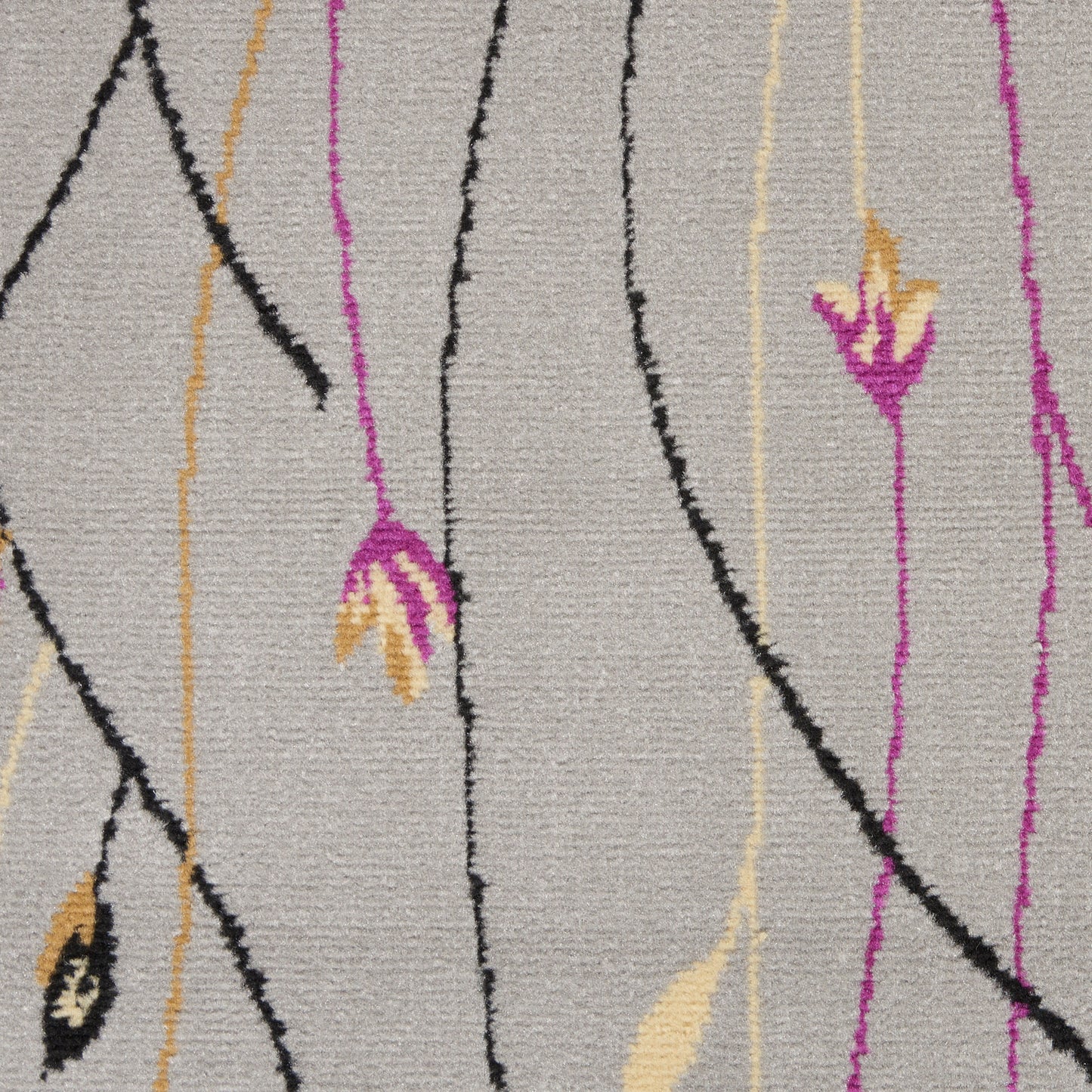 Beige woven rug with abstract magenta, black and mustard vertical lines and small floral accents for modern decor.