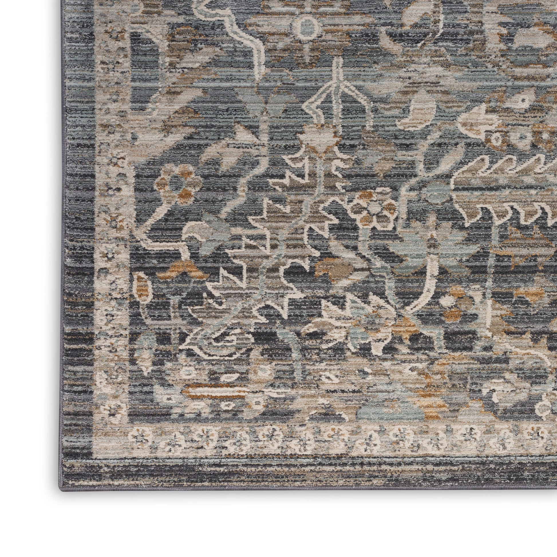 Corner view of a blue-gray ornate runner rug with ivory floral vines, tan accents, and a double beige border.